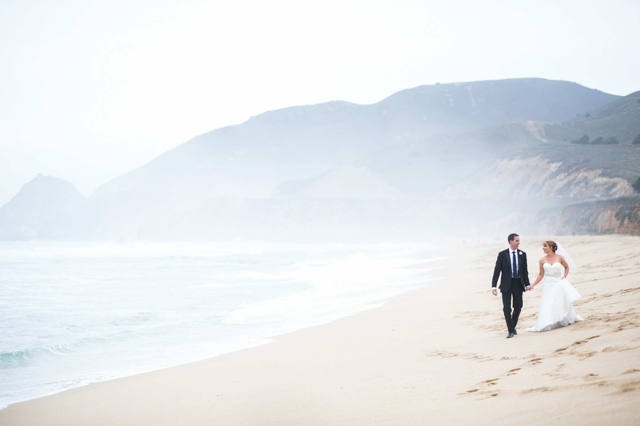 bride and groom walking along the beach near Oceano Hotel and Spa